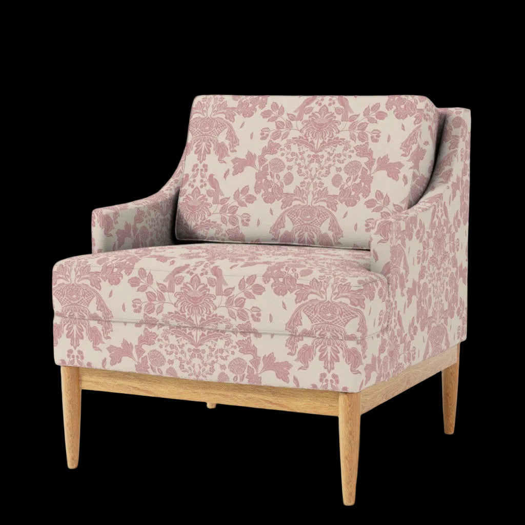 A mid-century modern accent chair with a dusty pink damask floral pattern on a cream fabric, supported by light natural wood legs, shown against a plain white background.