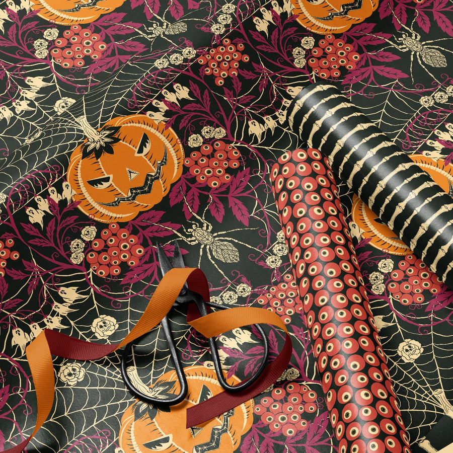 Halloween-themed wrapping paper with pumpkins, ribbons, and ribbons on a dark background