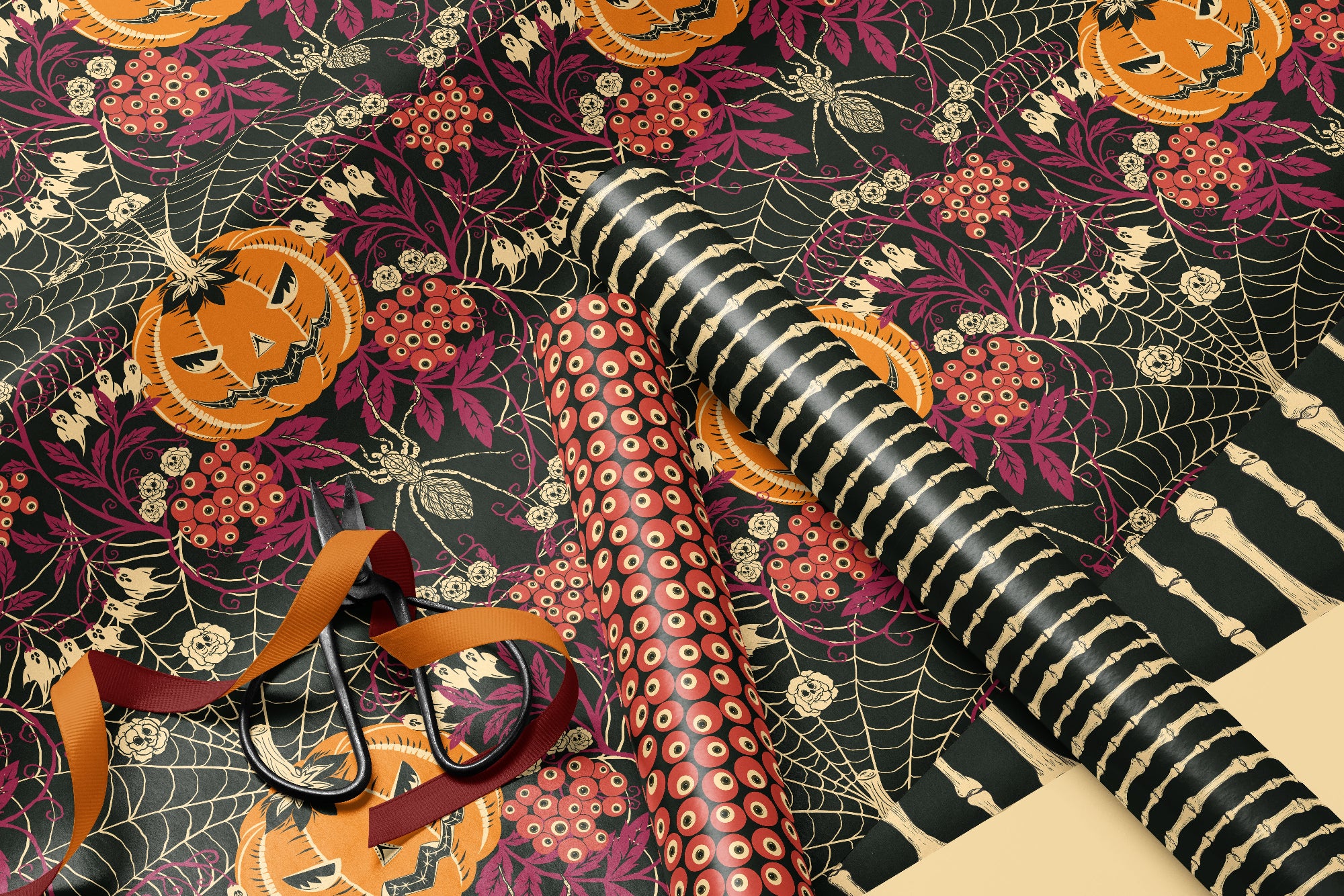 Halloween-themed wrapping paper with pumpkins, ribbons, and ribbons on a dark background