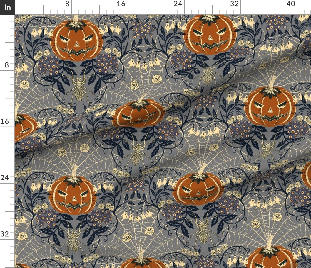 Halloween-themed fabric with pumpkins and spider webs on a blue background