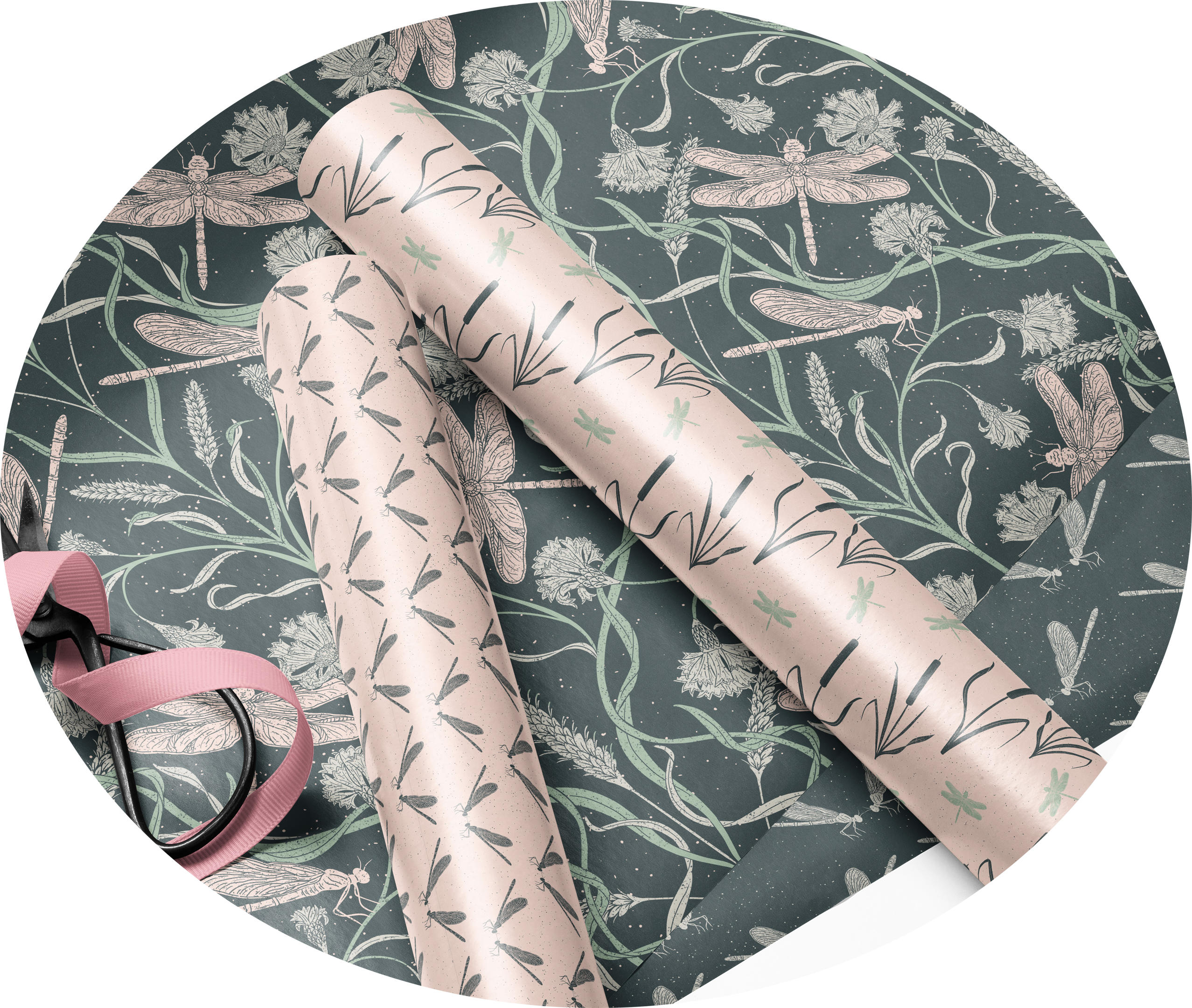 Close‑up mockup of two coordinating gift‑wrap rolls featuring botanical and dragonfly patterns in soft pink and deep green. Shown with ribbon and scissors, highlighting the mini collection’s matching floral and insect‑themed designs